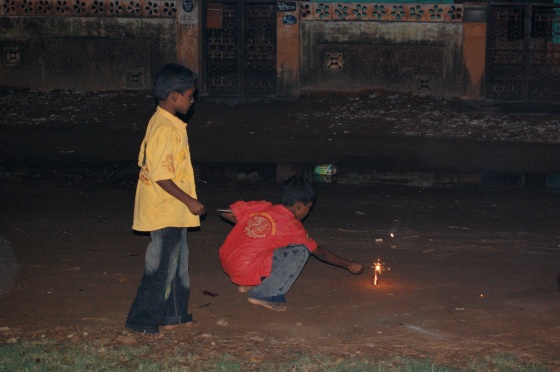 the children lighting the firecrackers